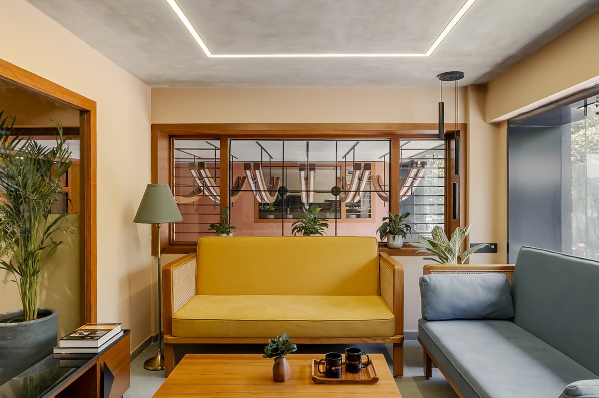Daylit patient waiting lounge with timber seating at Prismaa OncoImaging, Surat